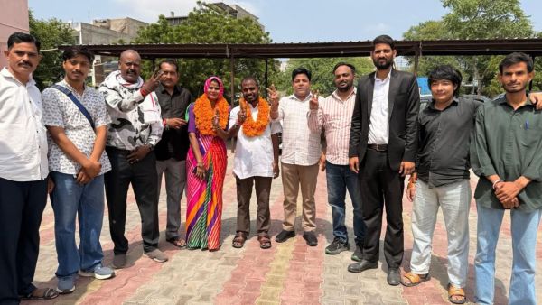 Congress's Suman Bhati, who has won from ward 72 in Jaipur, poses with husband Ramesh and supporters