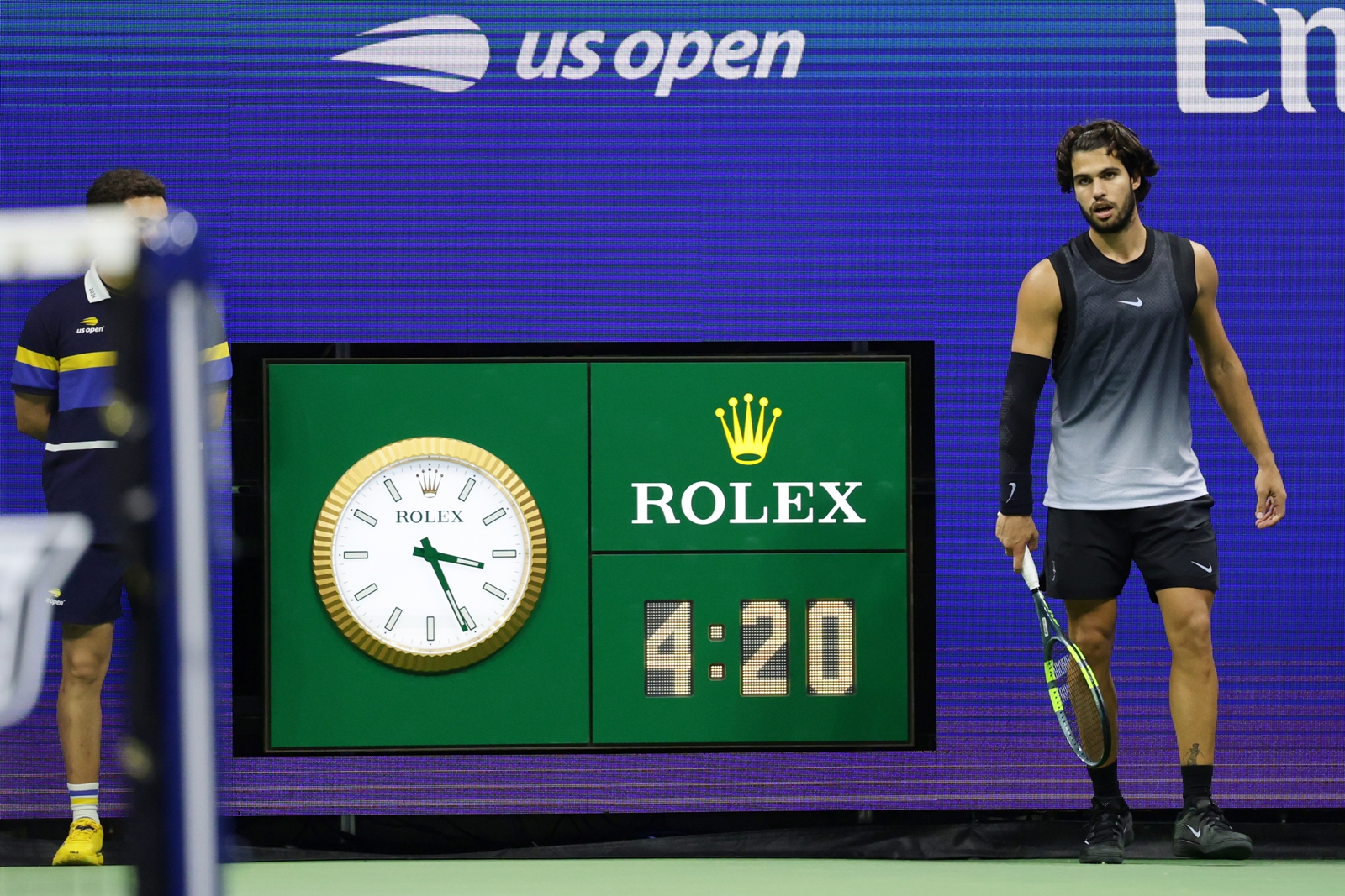 The clock reads 3:21 a.m. as Carlos Alcaraz, of Spain, plays in the fifth set against Ben Shelton, of the United States, during the quarterfinal round of the U.S. Open tennis championships, early Wednesday, Sept. 9, 2026, in New York.