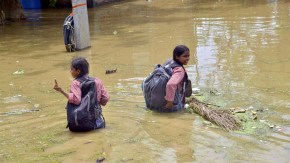 India Weather Today: School students wade through floodwater amid the rise in Ganga River's water level at Bind Toli, in Patna on Thursday. (ANI Photo)