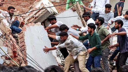 Rescue operation underway after a building collapsed near Satya Niketan at South-West Delhi, in New Delhi on Sunday. (ANI Video Grab)