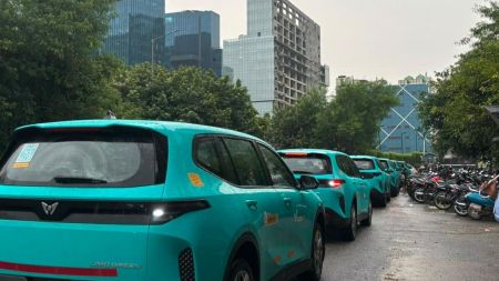 Cars line up outside the basement parking area of Urbtech Trade Centre in Noida's Sector 132, waiting to charge their vehicles. (Express Photo by Drishti Jain)