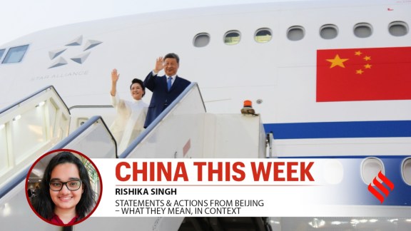 Chinese President Xi Jinping and his wife, Peng Liyuan, wave as they board a plane at the end of their visit to Cairo, Egypt, Sept. 2.