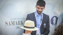 World champion Gukesh D gives an autograph to a young fan after winning his third round match at the Chess Olympiad in Samarkand. (Photo: Michal Walusza / FIDE)