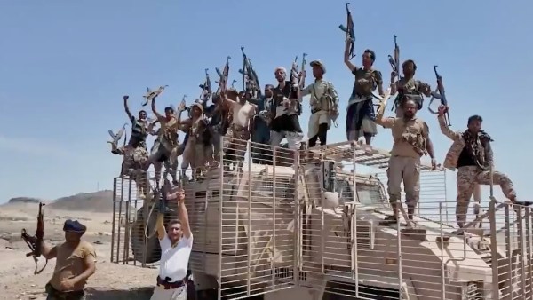 Houthi fighters atop a military vehicle in Dhubab district, Taiz province, Yemen.