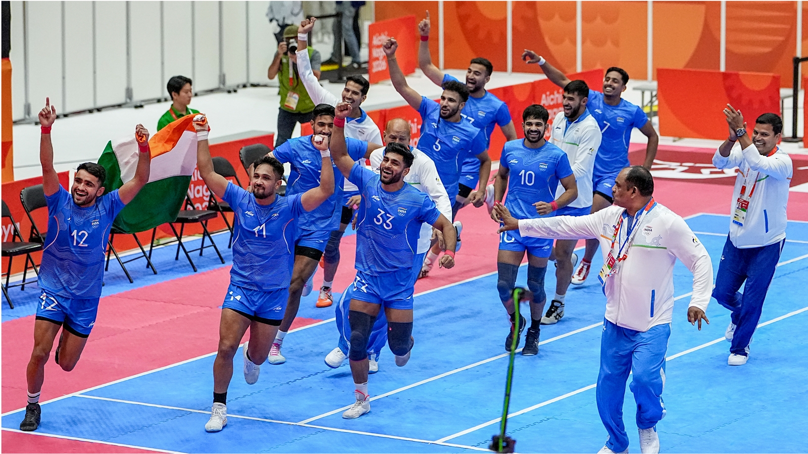 Inamdar (wearing jersey no.33) and the rest of the Indian team celebrate winning gold on Saturday at the 2026 Asian Games.