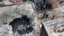 People inspect damage and debris at a building that Iranian media said was hit by a U.S. strike while a wedding celebration was taking place there, in Kuhestak, southern Iran.
