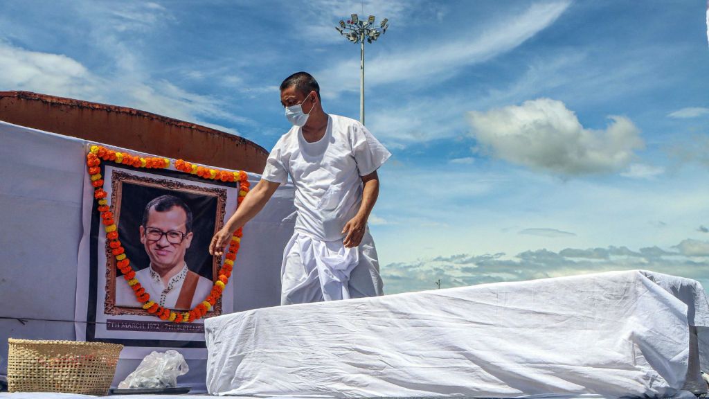 Imphal West, Sep 09 (ANI): A family member stands near the mortal remains of musician and music teacher Chongtham Vikram Singh, who was beaten to death in Delhi, at Imphal Airport, in Imphal West on Wednesday. (ANI Photo)