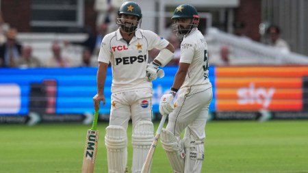 Pakistan's Mohammad Rizwan, left, stands with batting partner Saud Shakeel as they await third umpire's decision on Rizwan's wicket on day four of the second cricket test match between England and Pakistan in London, Sunday, Aug. 30, 2026. (AP Photo)