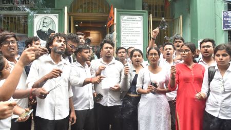Students protesting outside Surendranath Law College after being barred from appearing for examinations over low attendance, demanding permission to sit for the exams, as the college’s vice-principal Dr. Mohammadi Tarannum leaves the campus.Express photo.