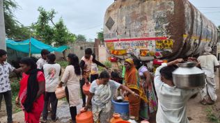 Villagers collect drinking water from a tanker amid a worsening water shortage in Tulshi. (Express)