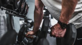 Person lifting weights during a progressive strength training workout