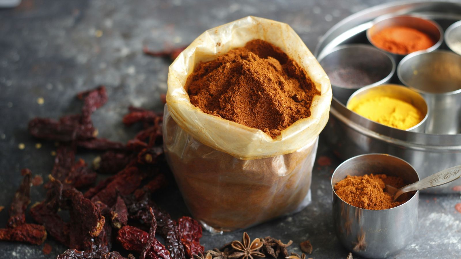 Turmeric powder and fresh turmeric roots used in Indian cooking