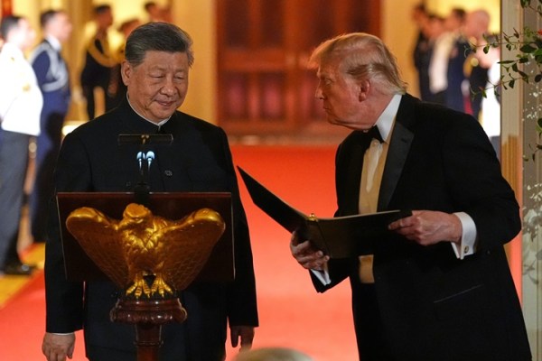 US President Donald Trump talks with China's President Xi Jinping during a State Dinner in the East Room of the White House.