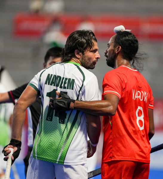 India's Hardik Singh with Pakistan's Nadeem Ahmad during the men's semifinal hockey match. (PTI)