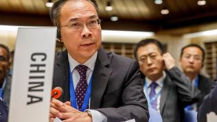 China's Ambassador Song Li asks the floor after moving a placard identifying his country, during the 146th session of the World Health Organization Executive Board, at the World Health Organization (WHO) headquarters in Geneva, Switzerland, Monday, Feb. 3, 2020. (Salvatore Di Nolfi/Keystone via AP, File)