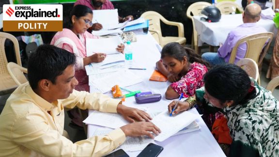 Form 6 mess: People served SIR (Special Intensive Revision) notices arrive at Appasaheb Kulkarni Primary School in Gokhalenagar on Monday with their documents. (Express Photo - Arul Horizon)