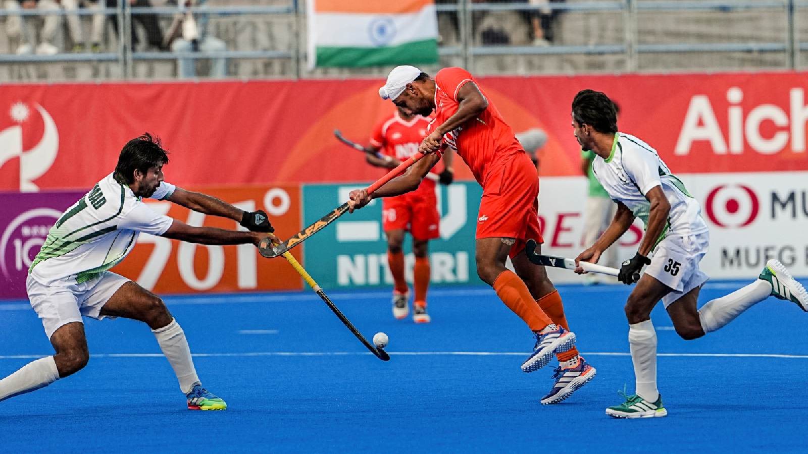 India's Mandeep Singh, centre, vies for the ball during a men's semifinal hockey match between India and Pakistan, at the ongoing 20th Asian Games, in Kakamigahara, Japan, Thursday, Oct. 1, 2026.