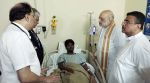 Union Home Minister Amit Shah and West Bengal Chief Minister Suvendu Adhikari inquire about the health of one of the admitted victims of the Chorbagan Durga Puja pandal stampede (Oct 17) at Apollo Hospital, in Kolkata on Sunday. (ANI Video Grab)