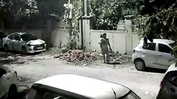 The man, who was carrying a child, was seen arriving with garbage