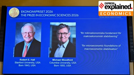 Robert E. Hall and Michael Woodford are shown on the screen as they are announced as the laureates of the Sveriges Riksbank Prize in Economic Sciences in Memory of Alfred Nobel (TT News Agency via AP)