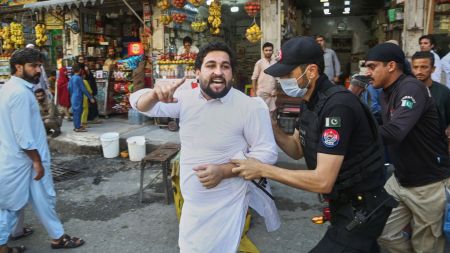 Police officers detain a supporters of imprisoned former Prime Minister Imran Khan's party during a protest against the Pakistani president declared a state of emergency in northwestern Khyber Pakhtunkhwa province and suspended its government, in Peshawar, Pakistan, Monday, Oct. 12, 2026. (AP Photo)