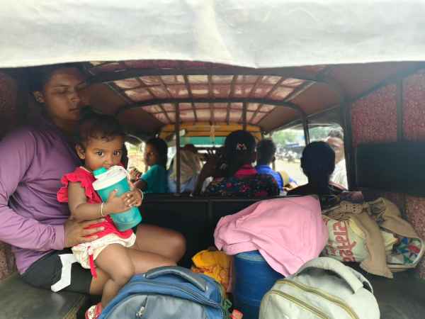 Women, packed in an auto, return from the stadium.