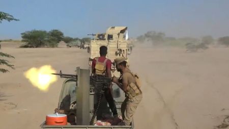 This image taken from undated video released by the Yemeni government-allied Southern Giants Brigades media office shows, what the group says, are its fighters firing a weapon mounted on a pickup truck during clashes with the Iran-backed Houthi group in Dhobab district, Taiz, Yemen. (Southern Giants Brigades Media Office via AP)