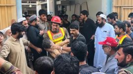 A rescue worker carries an injured child after rescuing him from the rubble of a roof collapse at a private school, in Peshawar, Pakistan, Thursday, Oct. 15, 2026. (AP Photo/Arif Khan)