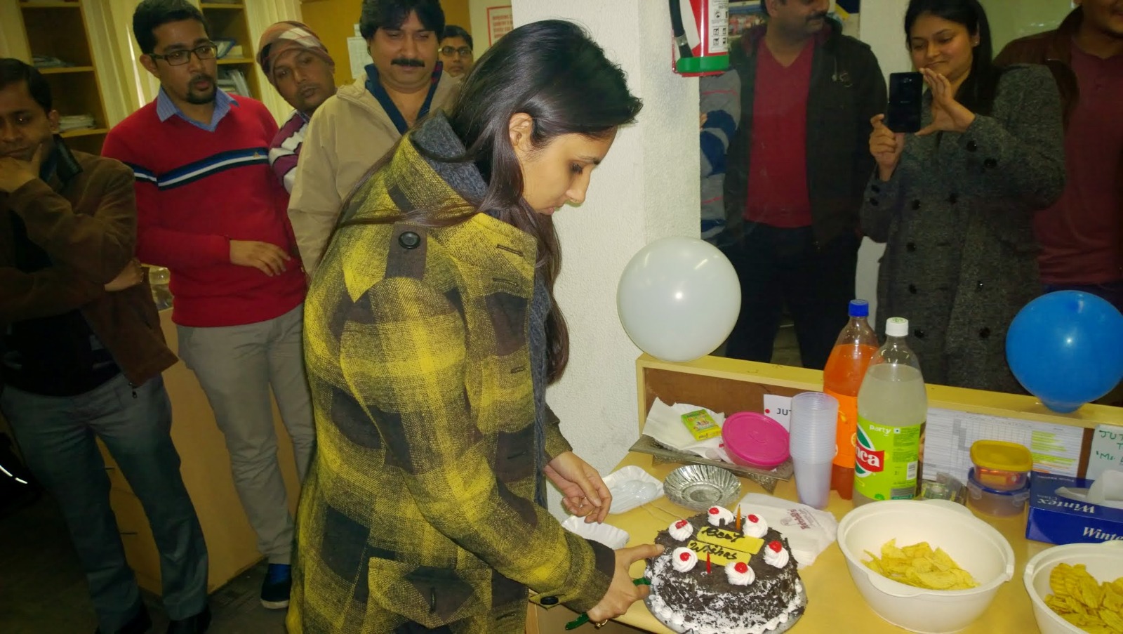 Priyanka Choudhary cutting a cake at her farewell ceremony from the Immunization Technical Support Unit (ITSU) in Delhi