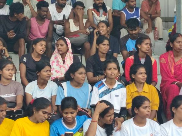 Punita Devi (in black and wearing bangles) and others await their turn at the stadium.
