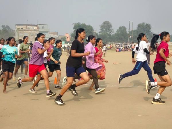 Punita Devi (in black T-shirt) takes her lap in the shoes she borrowed from her friend