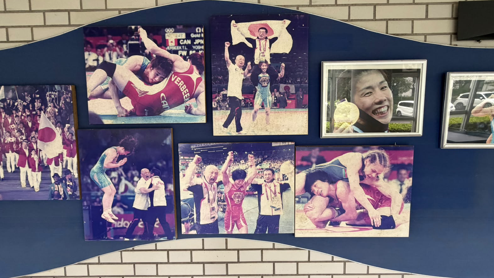 Photos of successful alumni from the Shigakkan University displayed on the walls.