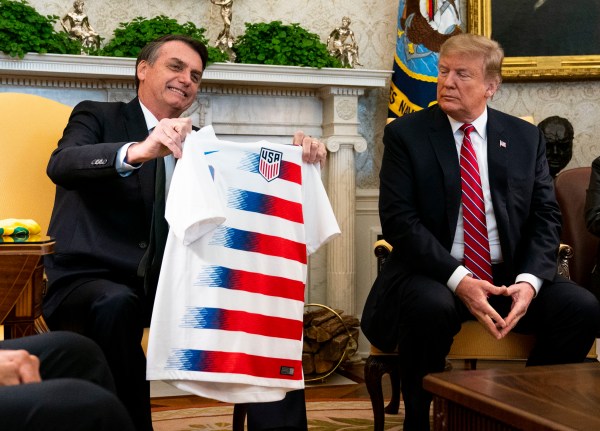 President Donald Trump exchanges national team soccer jerseys with President Jair Bolsonaro of Brazil, during a meeting in the Oval Office at the White House, in Washington, March 19, 2019. (Doug Mills/The New York Times)