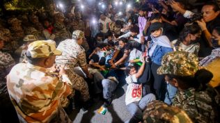 Security personnel remove protesters who had gathered near Palika Bazaar Gate No 2 to demand the resignation of Chief Election Commissioner Gyanesh Kumar over the alleged irregularities in Special Intensive Revision of electoral rolls. (Express Photo by Praveen Khanna)