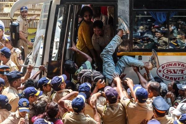 Tribal students bring put into police buses outside Tilak Bhavan