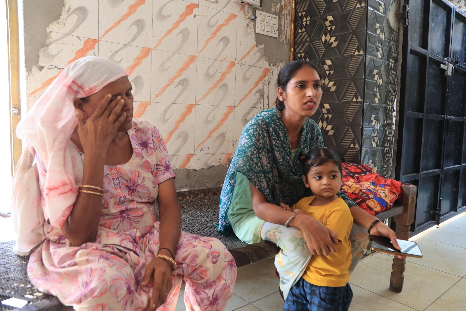 Amandeep Kaur, wife of Maninder Singh, with her mother-in-law Manjit Kaur in their house in Bagrian village.