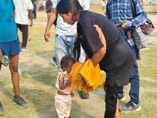 Yashoda Devi tends to her daughter Myra at the stadium