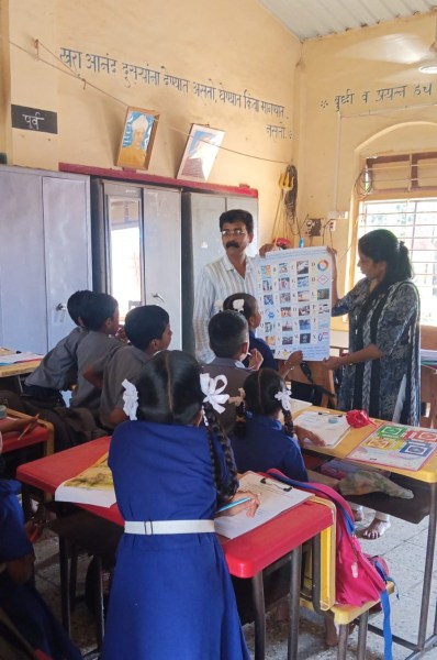 A colourful classroom chart begins with A for Alert, B for Bunker and C for Cyclone, and introduces terms such as evacuation, mitigation, search and rescue, and tsunami early warning systems.