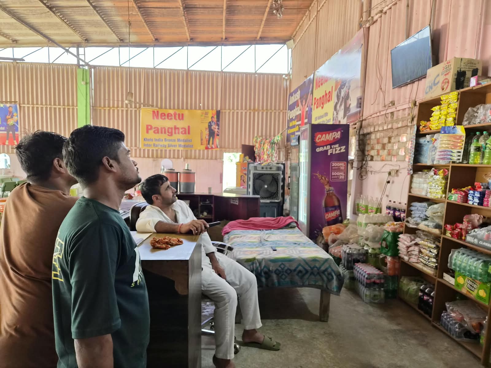 Ankush's father (seated) watching his son's gold medal bout. (Image via special arrangement)
