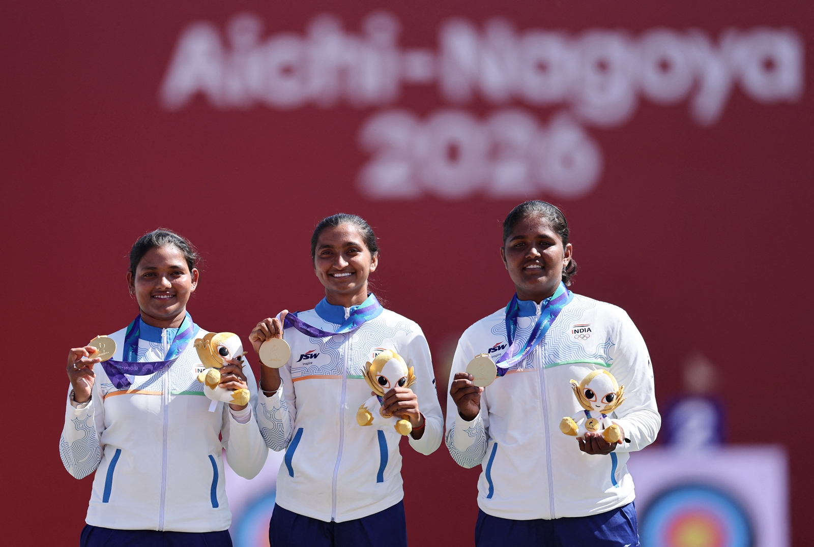 Gold medallist India's Kumkum Anil Mohod, Ankita Bhakat and Kirti celebrate on the podium during the victory ceremony (REUTERS Photo)
