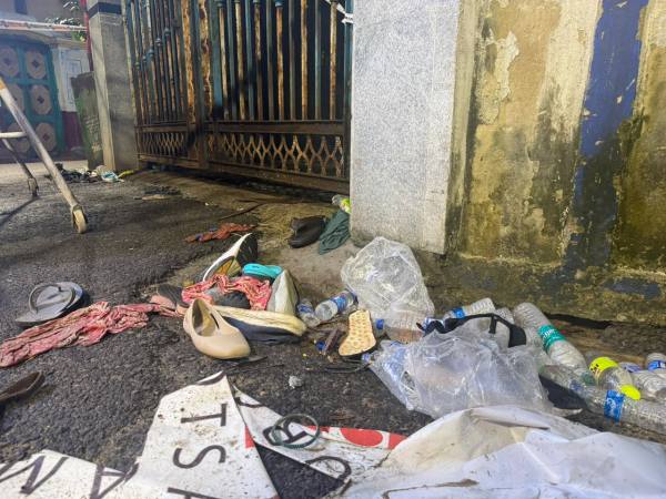 Shoes and belongings of victims lay strewn in front of the pandal. (Premankur Biswas)