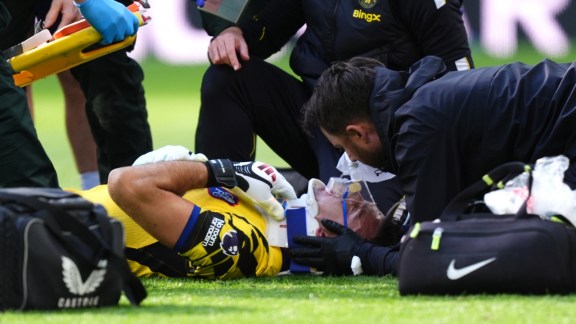 Chelsea goalkeeper Emiliano Martinez receives treatment for an injury during the English Premier League soccer match between Everton and Chelsea in Liverpool, England, Saturday, Oct. 17, 2026. (AP Photo)