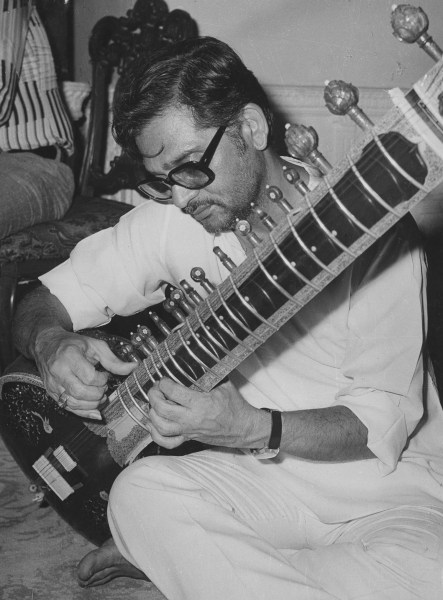 Lyricist Gulzar playing a sitar