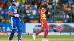 West Indies' Shamar Springer, right, celebrates the dismissal of India's Tilak Varma during the fifth T20 cricket match between India and West Indies in Bengaluru, India, Saturday, Oct. 17, 2026. (AP Photo)