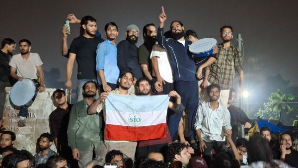 Jamia Millia Islamia students celebrate the announcement of the restoration of union and elections before Gulistan-e-Ghalib lawn, Jamia Millia Islamia on October 29. (Express Photo by Syed Ilham Jafri)