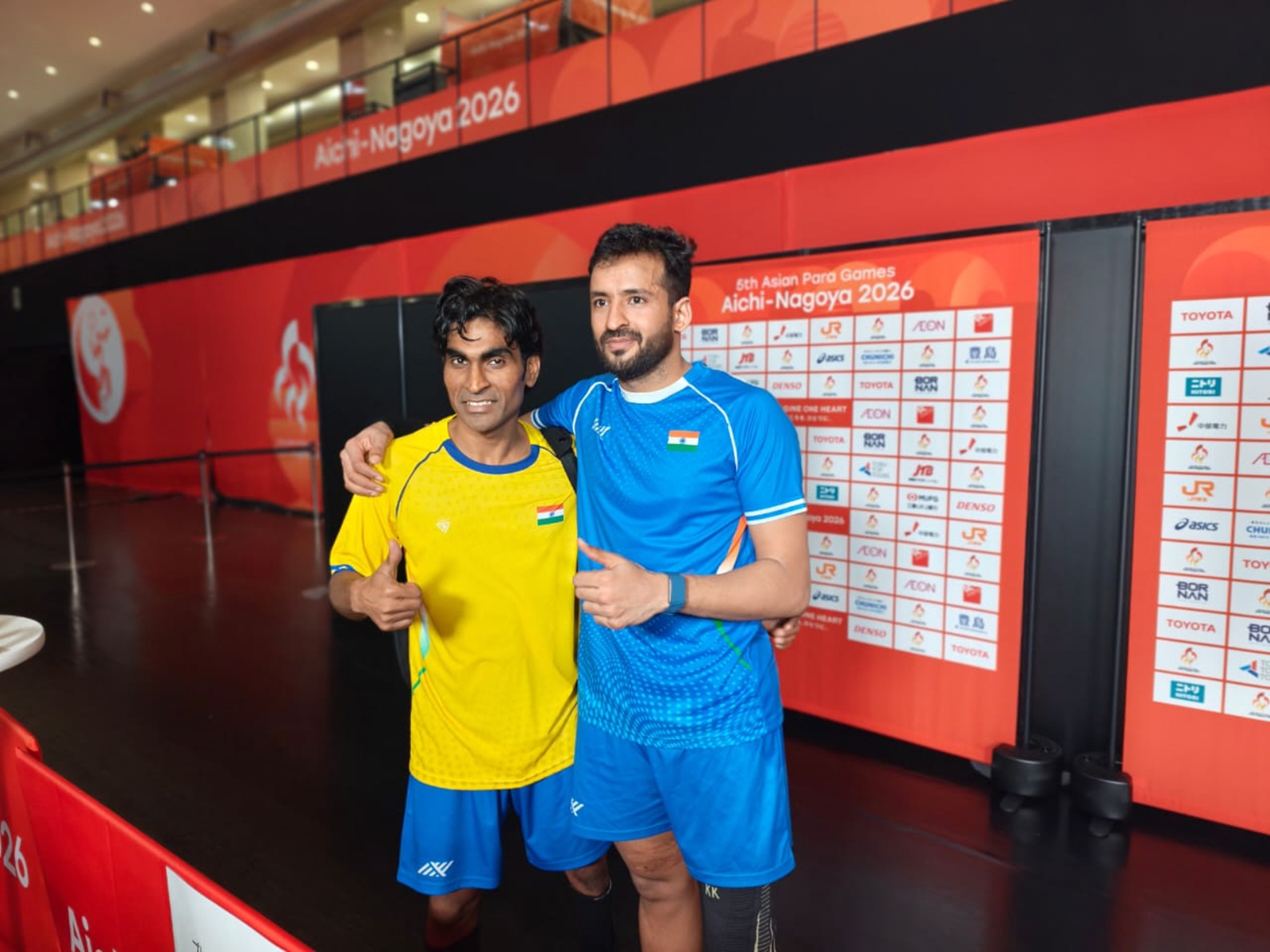 Nitesh Kumar, right, and Pramod Bhagat, after winning gold and silver medals respectively in men's singles SL3 event at the Asian Para Games, in Nagoya, Japan. (PCI Photo)