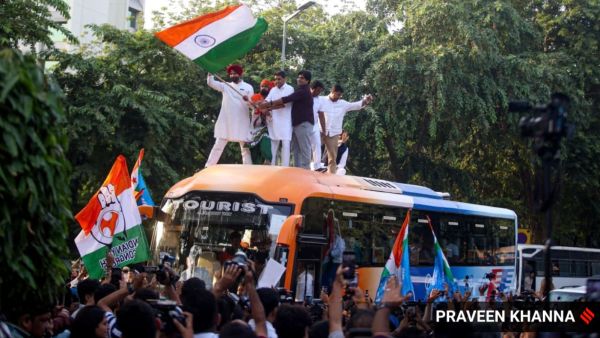 Congress agitators stand atop a bus on Day 2 of their anti-CEC protest in New Delhi. (Express Photo by Praveen Khanna)