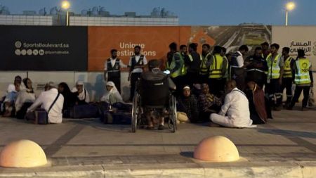 People gather outside a metro station on the road to King Khalid International Airport in Riyadh, Saudi Arabia, Saturday. (AP Photo)