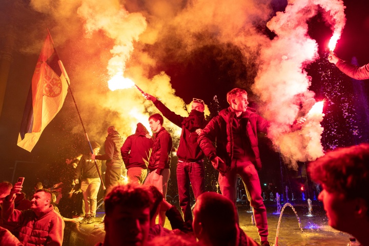 Young men light flares as people celebrate on a street a day after the student-led opposition won at the parliamentary elections in Belgrade, Serbia, Oct. 26. (AP Photo/Marko Drobnjakovic)